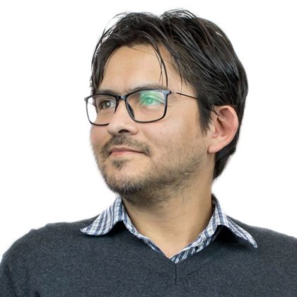 This is a portrait of WebDevStudios Backend Engineer, Mauricio Andrade. He is wearing glasses and looking away from the camera.