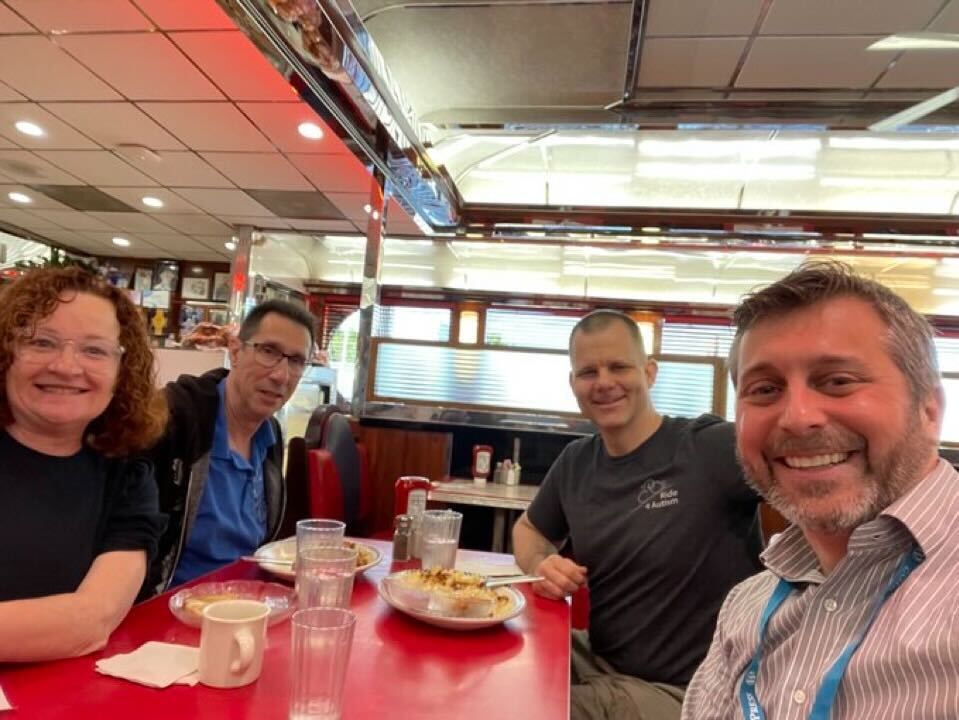 This is a photo of Account Manager Laura Byrne and Principal Engineer Sal Ferrarello having lunch with WebDevStudios clients at WordCamp Montclair 2024.