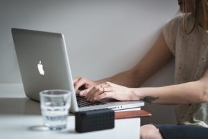 This is a photo of a person on a Mac Book Air laptop.