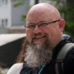 This is an outdoor portrait of Topher DeRosia, Backend Engineer at WebDevStudios.